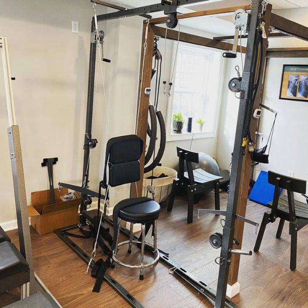 Therapy room at 'The Chiropractic Source' with spinal care equipment and treatment chairs.