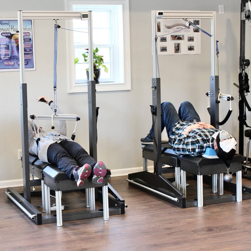 Patients undergoing spinal decompression therapy at 'The Chiropractic Source' clinic.